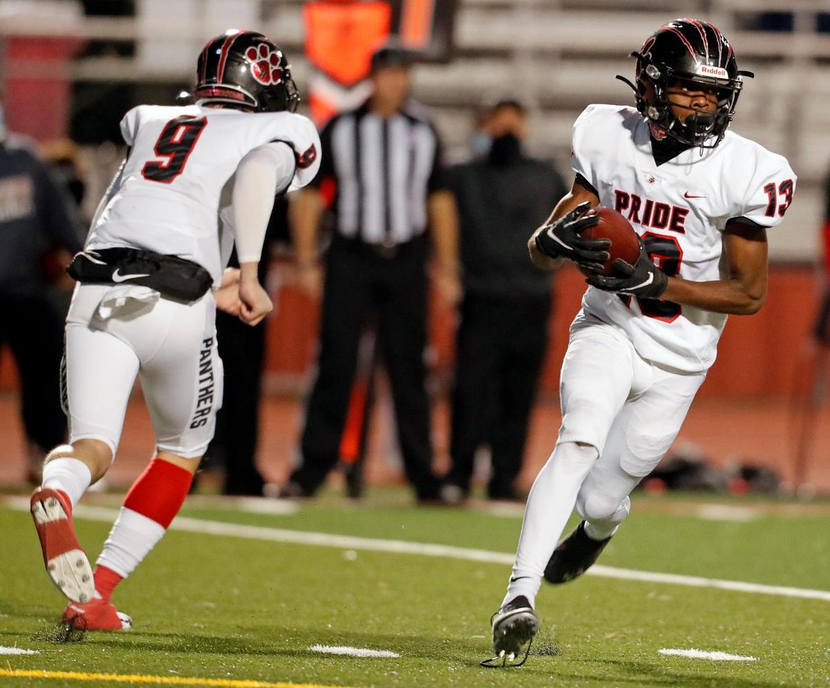Colleyville Heritage wide receiver Leon Covington (13) takes the pitch from quarterback AJ Smith-Shawver (9) during a 5A high school football game at Burleson ISD Stadium in Burleson , Texas, Friday, Nov. 27, 2020. Colleyville led 17-0 at the half. (Special to the Star-Telegram Bob Booth)