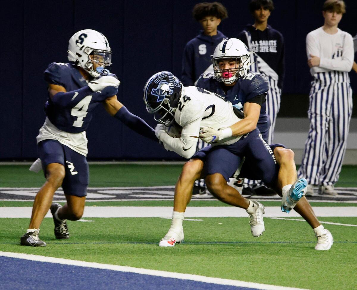 All Saints safeties Kevin Dodard (4) and Reid Watkins (25) attempt to keep Liberty Christian wide receiver Quinton Brown (24) from scoring but Brown eventually fumbled into the hands of team mate wide receiver Brady Janusek (10) who scored in the first half of a TAPPS Region 2 semi-final football playoff game at The Ford Center in Frisco, Texas, Saturday, Oct. 25, 2023.