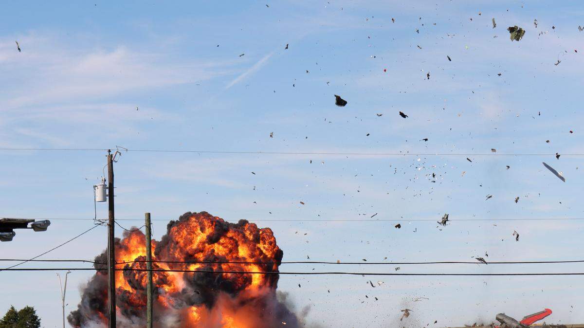 In this photo provided by Nathaniel Ross Photography, a historic military plane crashes after colliding with another plane during an airshow at Dallas Executive Airport in Dallas on Saturday, Nov. 12, 2022.