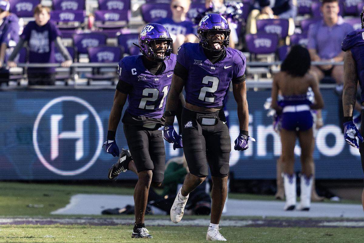 TCU safety Jamel Johnson (right) and safety Bud Clark celebrate after Johnson picked off Baylor quarterback Sawyer Robertson in the fourth quarter Oct. 18 at Amon G. Carter Stadium.