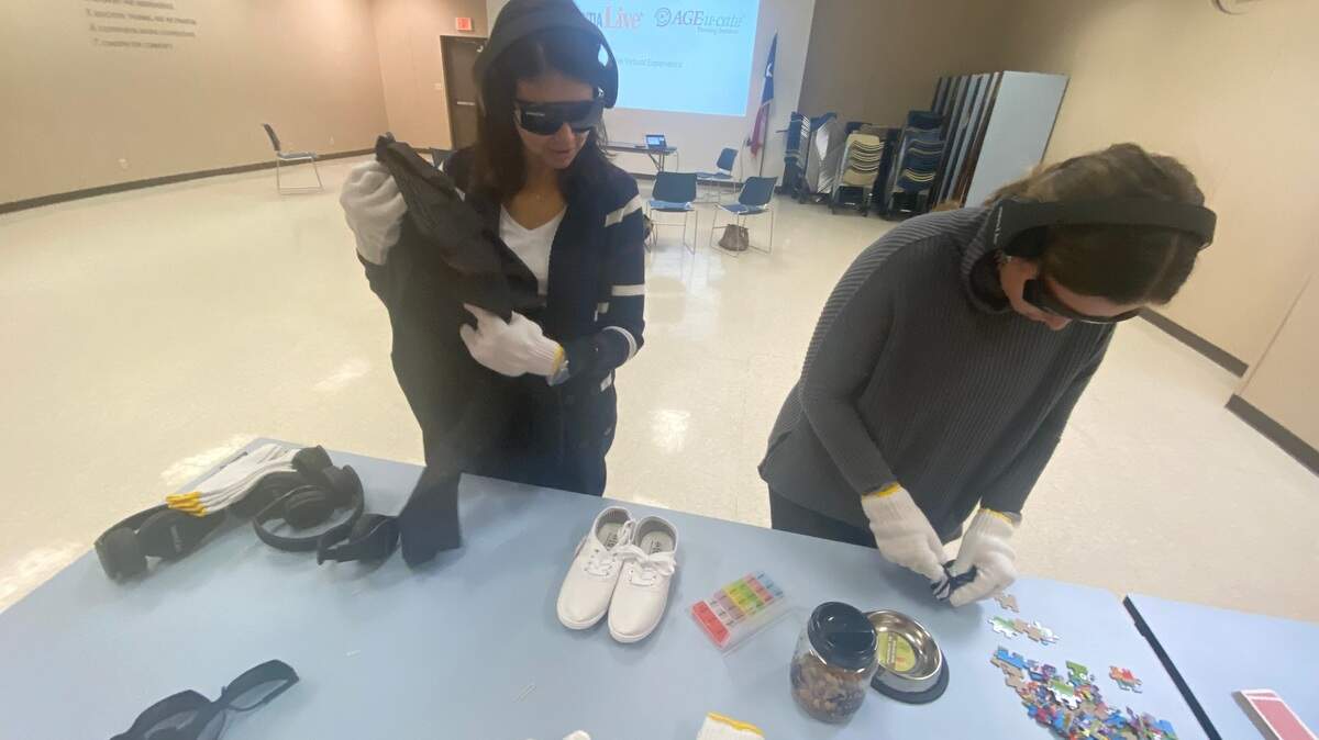 Trainees in the Dementia Friendly North Central/East Texas program use special glasses and gloves to simulate changes in vision and fine motor skills. They’re wearing headphones with a special soundtrack that confuses the healthy brain. Then, they’re asked to complete a number of tasks without fully understanding of what those tasks are.