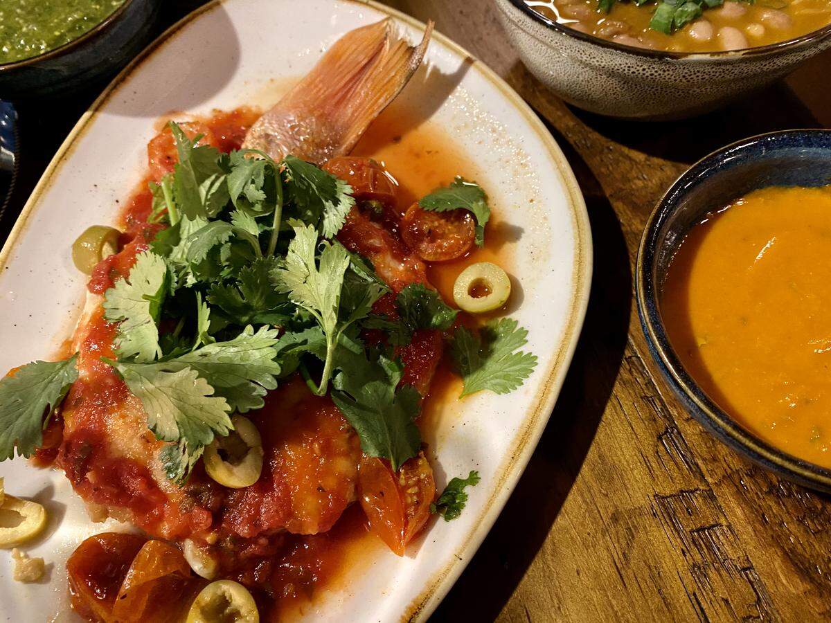 Snapper with beans plus the house salsas at Tinie’s in South Main Village.