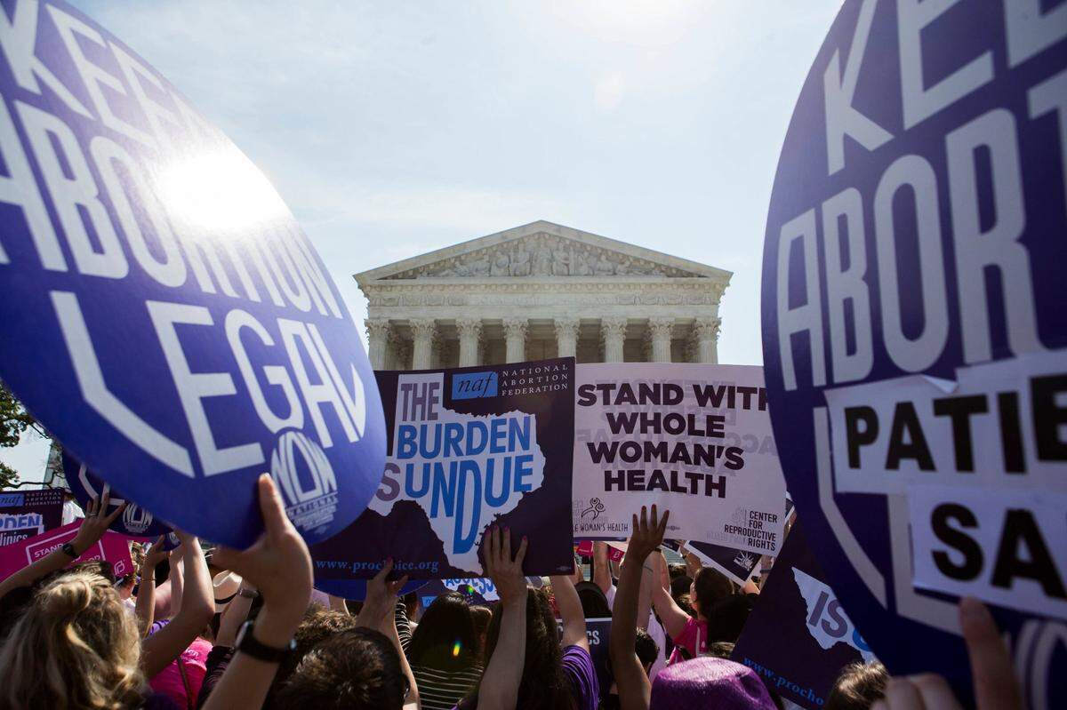 Pro-abortion rights activists rally in front of the U.S. Supreme Court in Washington, June 27, 2016. The court on Monday struck down parts of a restrictive Texas law that could have reduced the number of abortion clinics in the state to about 10 from what was once a high of roughly 40. (Zach Gibson/The New York Times)