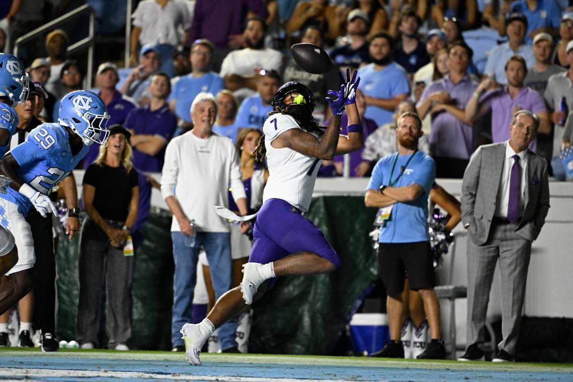TCU wide receiver Jordan Dwyer (7) catches a touchdown pass as North Carolina defensive back Marcus Allen (29) defends in the first quarter Monday at Kenan Stadium in Chapel Hill, N.C.