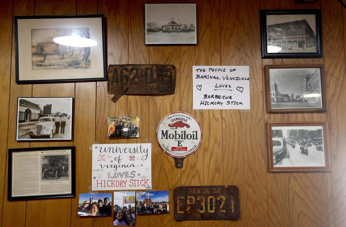 Photos, notes from customers and other items decorate the wall of Hickory Stick Barbecue in Everman.