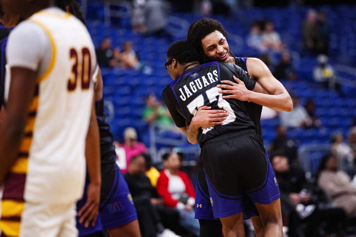 Mansfield Summit guards Jaxon Sneed and Javon Ross (33) hug each other in celebration as the seconds tick off the clock in the Class 5A Division II state championship game Saturday at the Alamodome in San Antonio.
