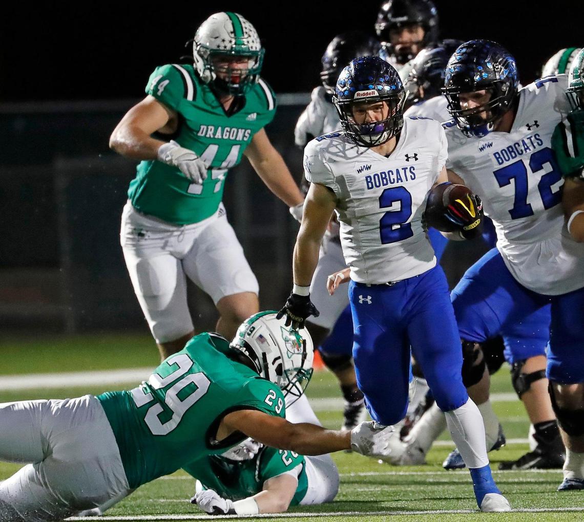 Byron Nelson’s Aaron Darden (2) avoids the tackle of Southlake Carroll linebacker Nigel Fodor (29) as he heads downfield in the first half of a District 4-6A football game at Dragon Stadium in Southlake, Texas, Friday, Oct. 28, 2022. Carroll led Byron Nelson 21-13 at the half. (Special to the Star-Telegram Bob Booth)