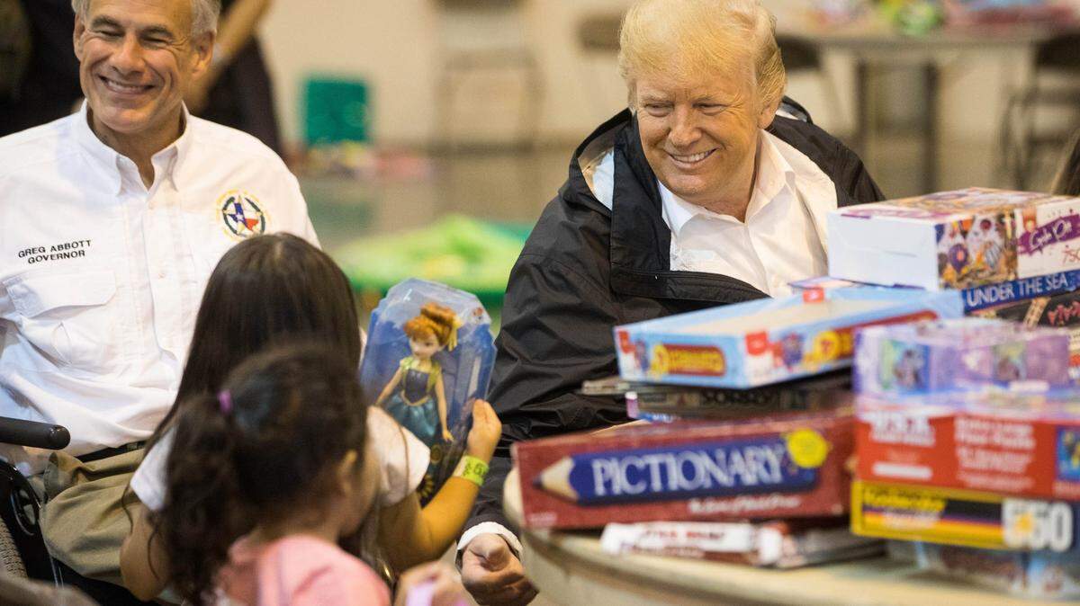 Sep 2, 2017; Pearland, TX, USA; President Donald J. Trump and Governor Greg Abbott   speak with children at the NRG Center. Mandatory Credit: Courtney Sacco/Caller-Times via USA TODAY NETWORK