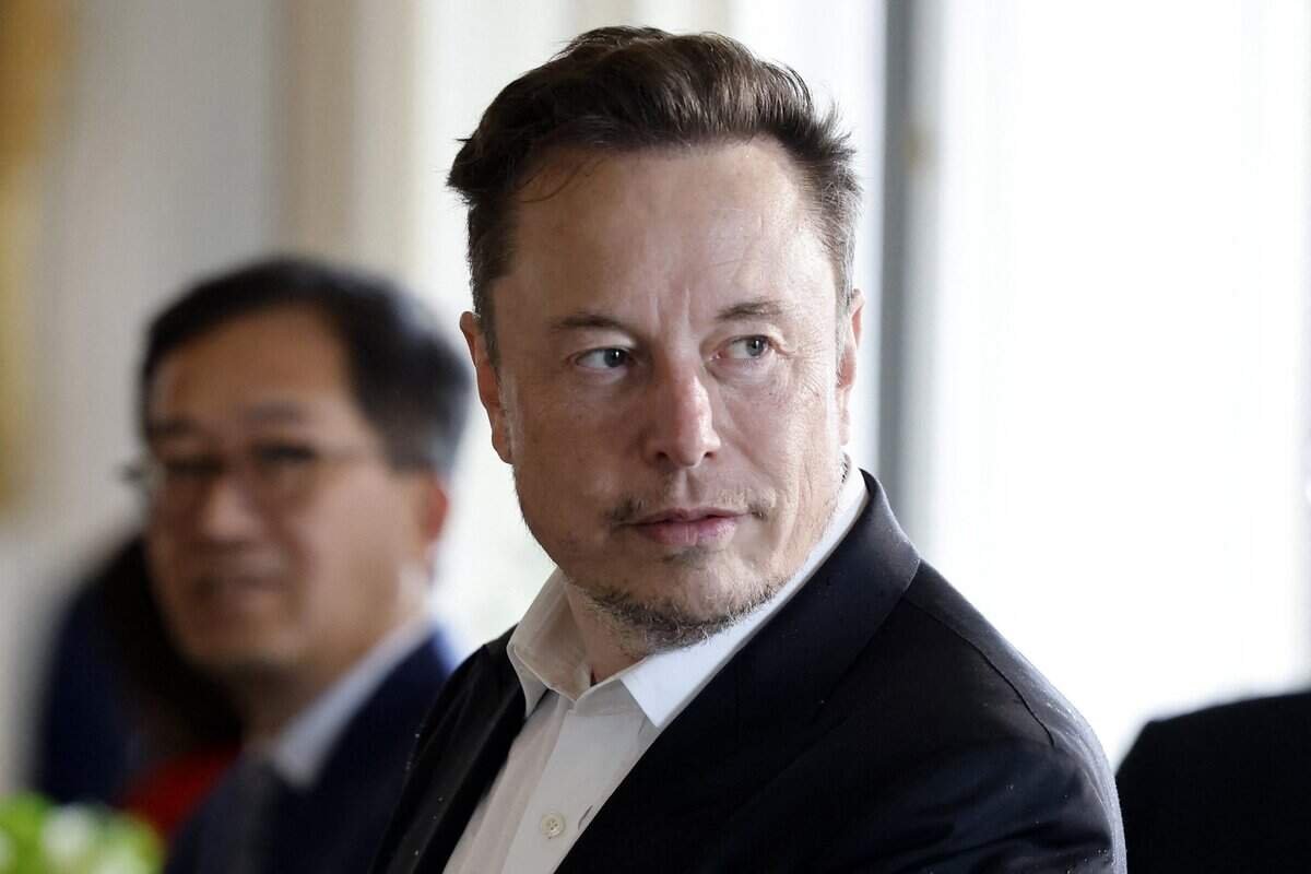 Tesla CEO Elon Musk looks on among other CEOs before a roundtable during the 6th edition of the “Choose France” Summit at the Chateau de Versailles, outside Paris on May 15, 2023. (Ludovic Marin/Pool/AFP/Getty Images/TNS)