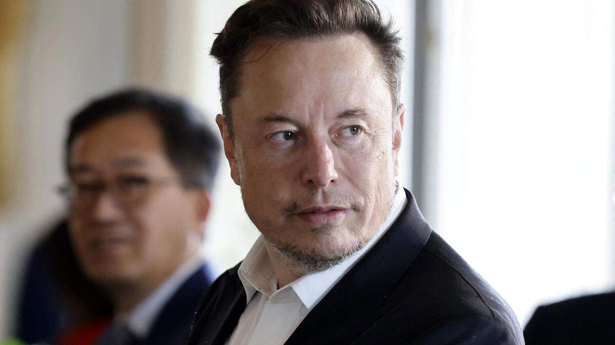 Tesla CEO Elon Musk looks on among other CEOs before a roundtable during the 6th edition of the “Choose France” Summit at the Chateau de Versailles, outside Paris on May 15, 2023. (Ludovic Marin/Pool/AFP/Getty Images/TNS)