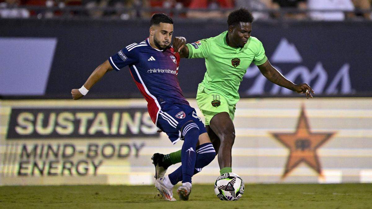 FC Dallas forward Enes Sali (99) and FC Juarez midfielder Aviles Hurtado (18) in action during the game between FC Dallas and FC Juarez at Toyota Stadium.
