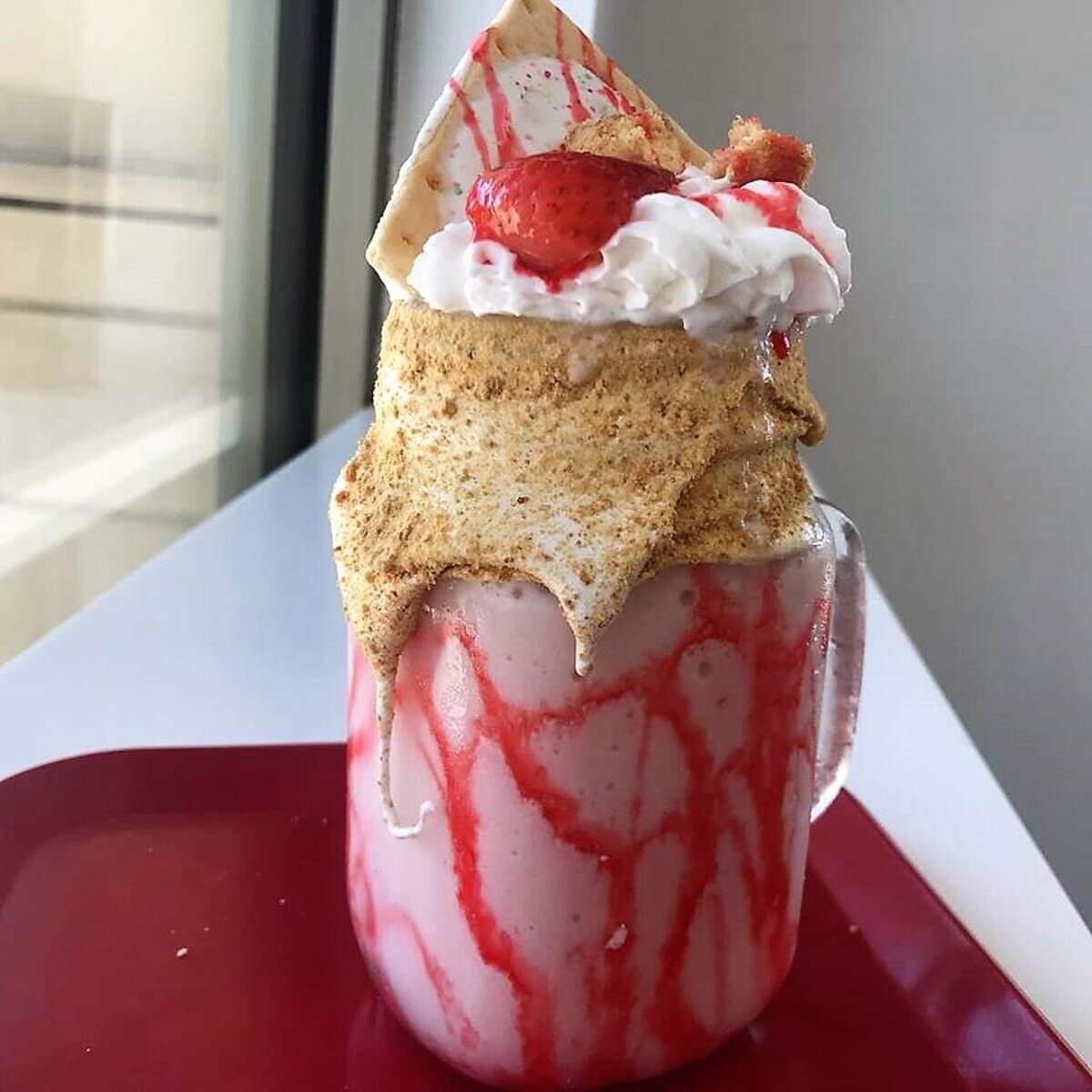 A "Straw-Quake" — vanilla frozen yogurt with strawberries, bits of New York cheesecake, marshmallow creme, graham cracker dust and, yes, that is a piece of a Pop-Tart on top — at Muggle Shakes in far north Fort Worth.