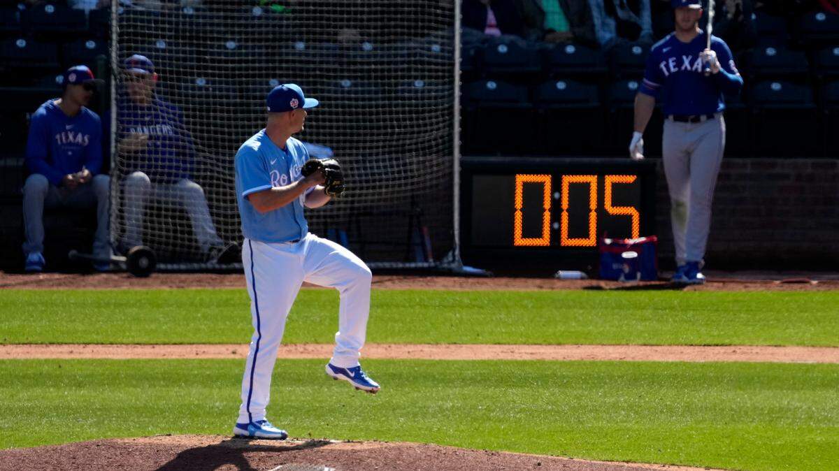 Kansas City Royals Nick Wittgren throws before a pitch clock runs down during a spring training game against the Texas Rangers.