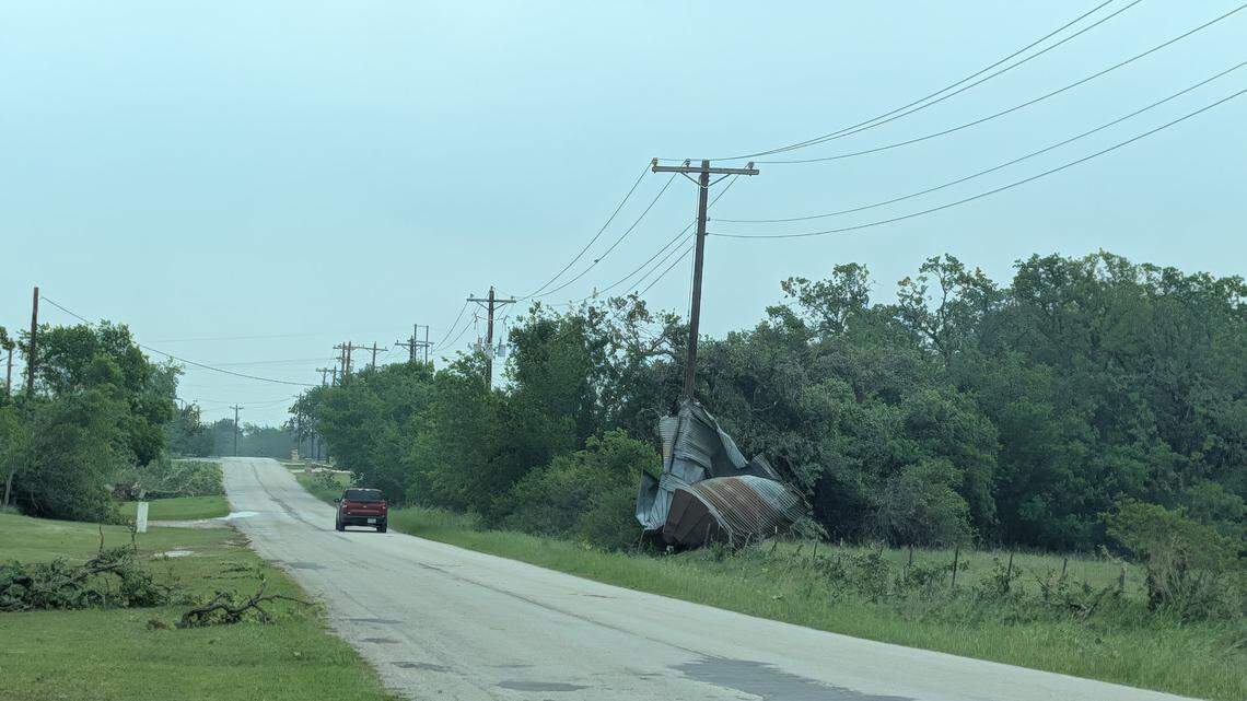 Scrap metal is wrapped around a power pole on JE Woody Road on Sunday, April 26, 2026, following Saturday night’s severe storm in Springtown, Texas.