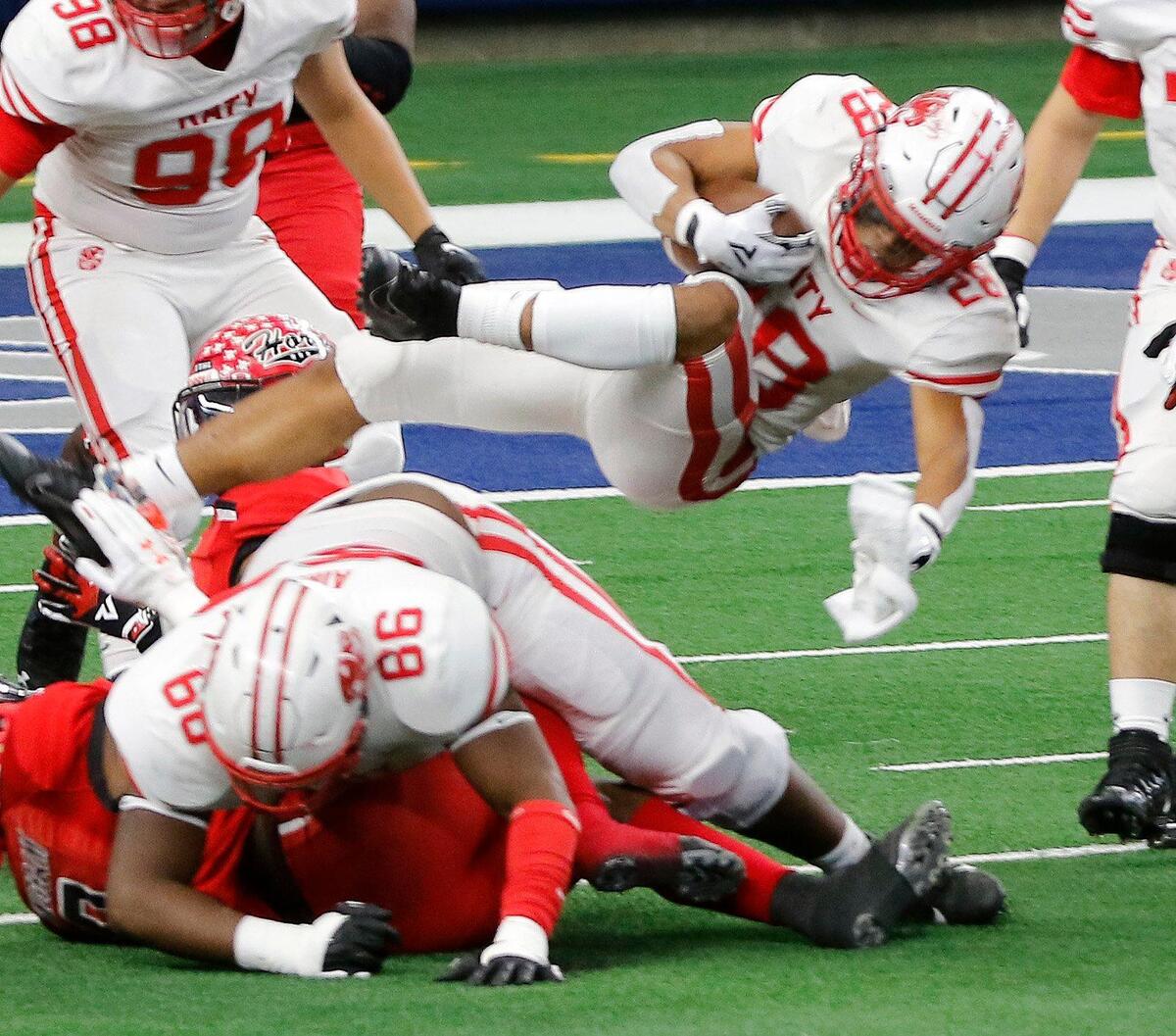 Katy running back Jalen Davis (28) flies over the line of scrimmage in the first half of the 6A D2 state title game at AT&T Stadium in Arlington, Texas, Saturday, Jan. 16, 2021. Katy led 24-0 after two frames. (Special to the Star-Telegram Bob Booth)