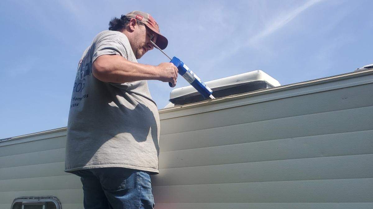 Bobby Crutsinger does some repair work on an RV. He and his wife Peggy, along with friends, renovate and rebuild old RVs and camping trailers into homes for homeless veterans.