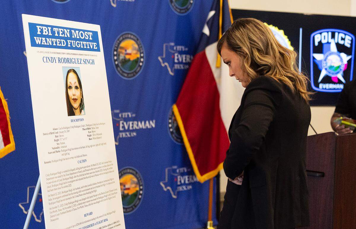Tarrant County Assistant District Attorney Ashlea Deener looks at a placard with Cindy Rodriguez-Singh listed as one of the FBI’s Ten Most Wanted Fugitives prior to a press conference on Tuesday, July 1, in Everman.. More than two years after 6-year-old Everman boy Noel Rodriguez-Alvarez went missing and was presumed dead, his mother, Cindy Rodriguez-Singh, has been added to the list.