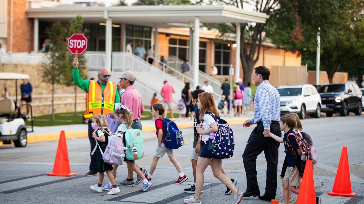 Parents walk their children to Tanglewood Elementary School on Monday, Sept. 13, 2021, in Fort Worth. The four parents who sued the Fort Worth school board over its mask mandate last August have come to a settlement with the board, including conditions for any mask mandates implemented in the current school year, according to a Friday news release from the district.