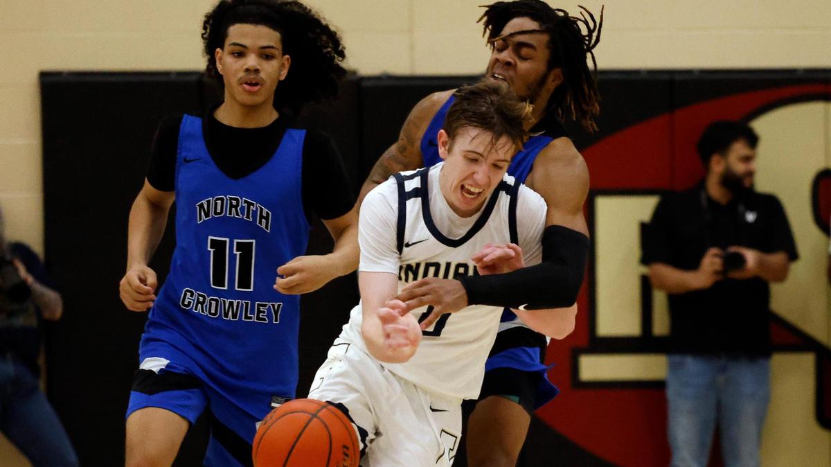 Keller guard Alex Peterson (0) is fouled on defensive end of the court by North Crowley wing KD Davis (1) during the fourth period of the Conference 6A Region 1 quarterfinals basketball playoffs at Saginaw High School in Saginaw, Texas, Tuesday, Feb. 27, 2024.