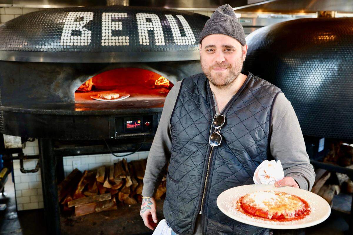 Chef Christian Petroni of the Food Network show “Chopped” shows off his chicken Parmesan Jan. 6, 2020 at his Yonkers, New York, restaurant, Fortina.
