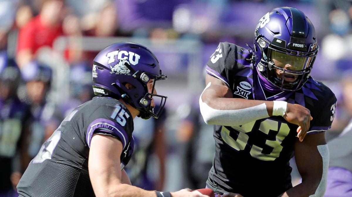 TCU quarterback Max Duggan (15) pulls the ball back from running back Kendre Miller (33) in the first half of Saturday’s loss to Oklahoma. The Horned Frogs have struggled to find consistency on offense this season.