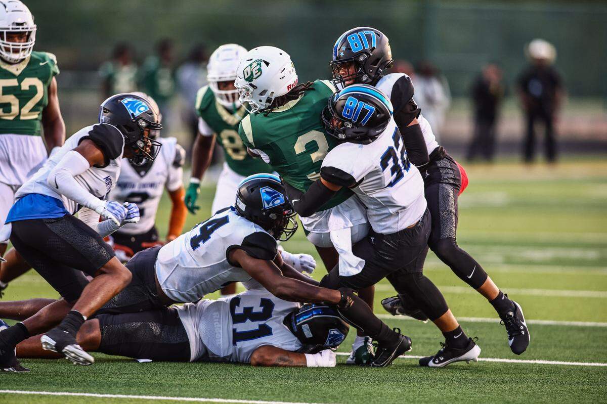 North Crowley linebacker Avery Dotson (32) and a host of Panthers tackle DeSoto quarterback Kelden Ryan (3) on Friday, September 6, 2024 at Eagle Stadium in DeSoto, Texas.