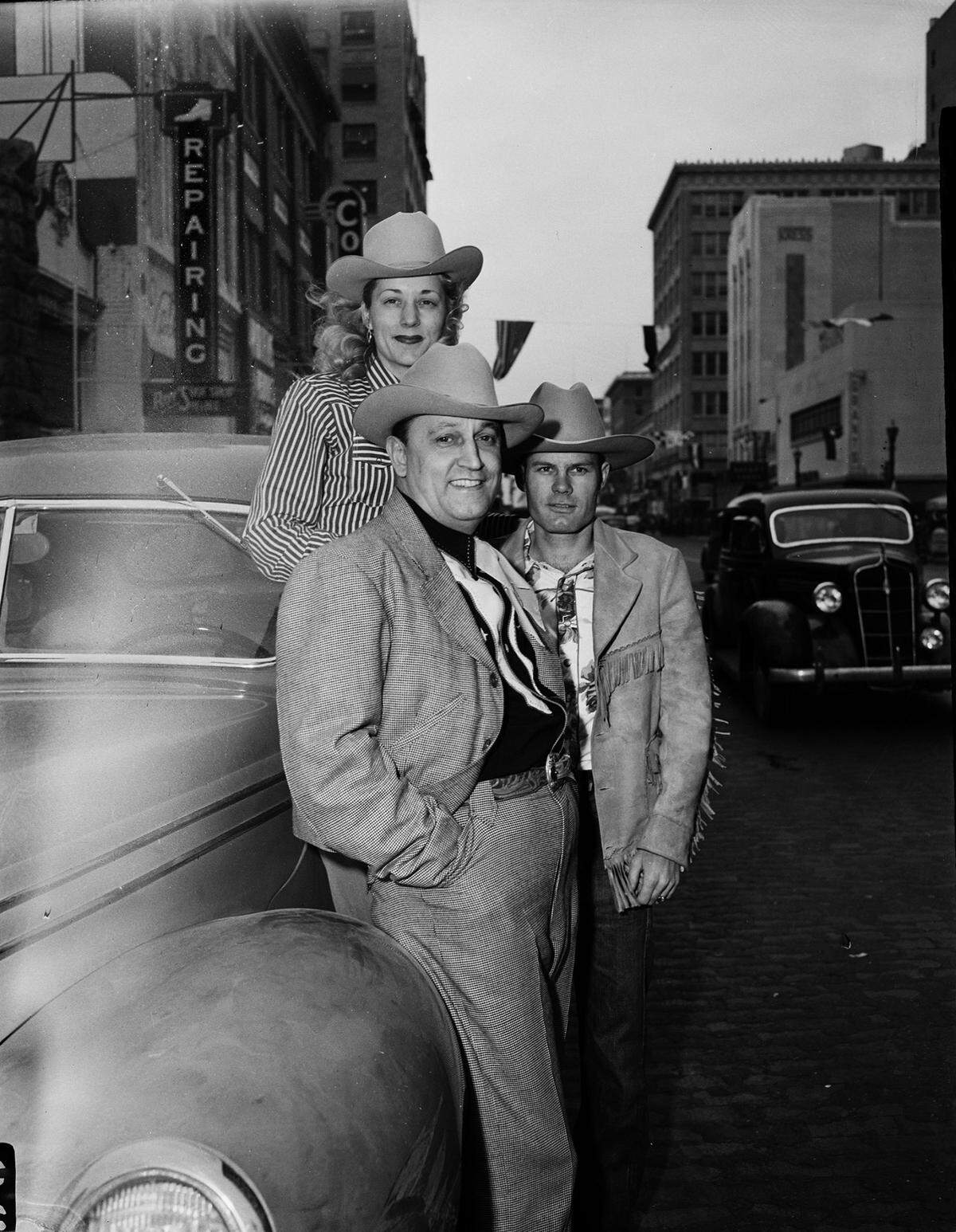 March 5, 1947: Watching the Southwestern Exposition and Fat Stock Show Parade are Miss Polly Boswell, R.M. Davidson and Texas Harner of Cleburne.