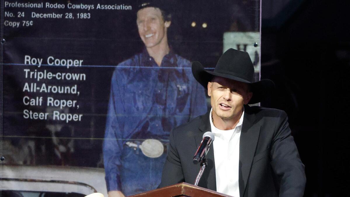 Clif Cooper shares some family memories during a memorial service for world champion calf roper Roy Dale Cooper at Cowtown Coliseum in Fort Worth on Monday.