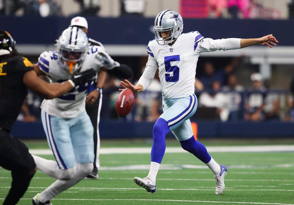 Dallas Cowboys Bryan Anger kicks the ball on a fourth down during the game against Washington Commanders on Sunday, Oct. 2, 2022, at AT&T Stadium in Arlington.