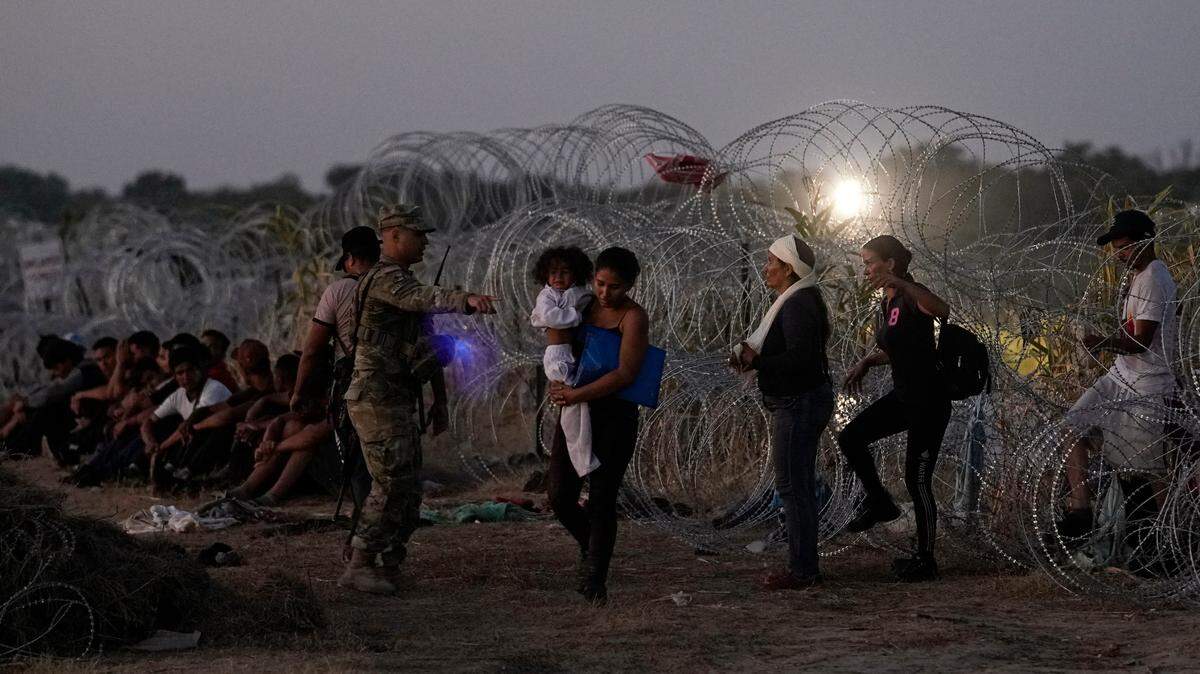 FILE - Migrants who crossed the Rio Grande and entered the U.S. from Mexico are lined up for processing by U.S. Customs and Border Protection on Sept. 23, 2023, in Eagle Pass, Texas.