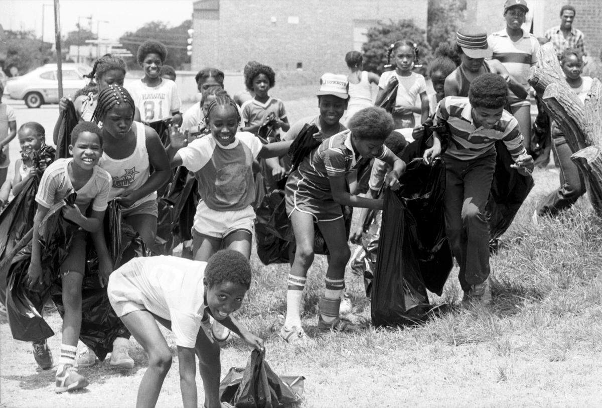 June 23, 1983: Girl Scouts and other children participated in a neighborhood cleanup in the Stop Six area. The children received 25 cents per bag of trash collected as well as a free lunch for their efforts.