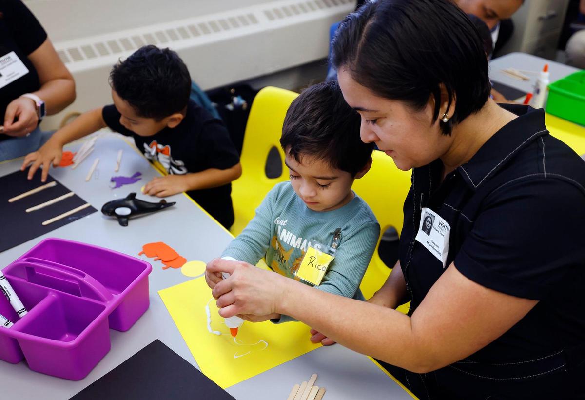 Yahaira Torres helps her 3-year-old son Ricardo with an educational project during a Zero to Five class on Wednesday, Oct. 30, at M.H. Moore Elementary School in Fort Worth.