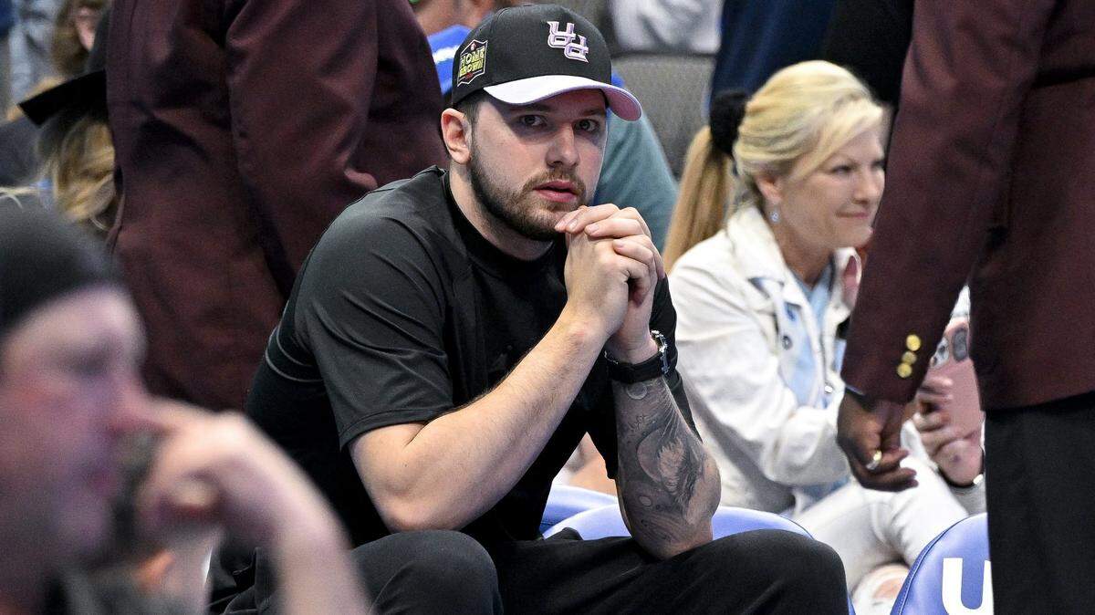 Luka Doncic (77) sits by himself during a timeout in the game between the Dallas Mavericks and the San Antonio Spurs. Doncic is pledging to pay for funerals for the victims of the Belgrade shooting.