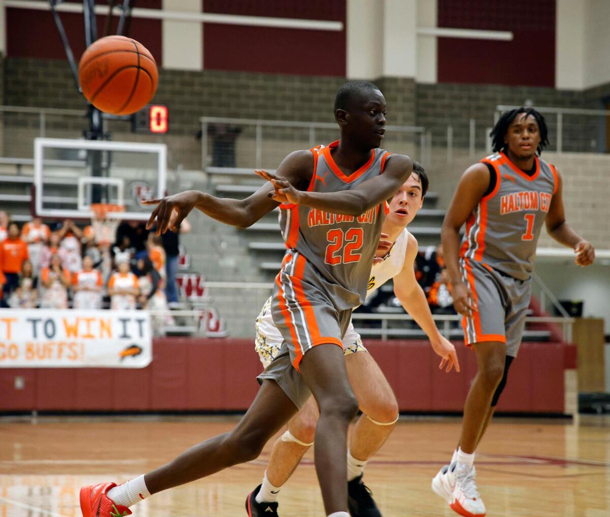 Haltom forward Kuol Atak (22) does a no-look pass to the corner in the first period of a UIL Conference 6A Division 1 boys bi-district basketball playoff game at Lewisville High School in Lewisville, Texas, Tuesday, Feb. 20, 2024.