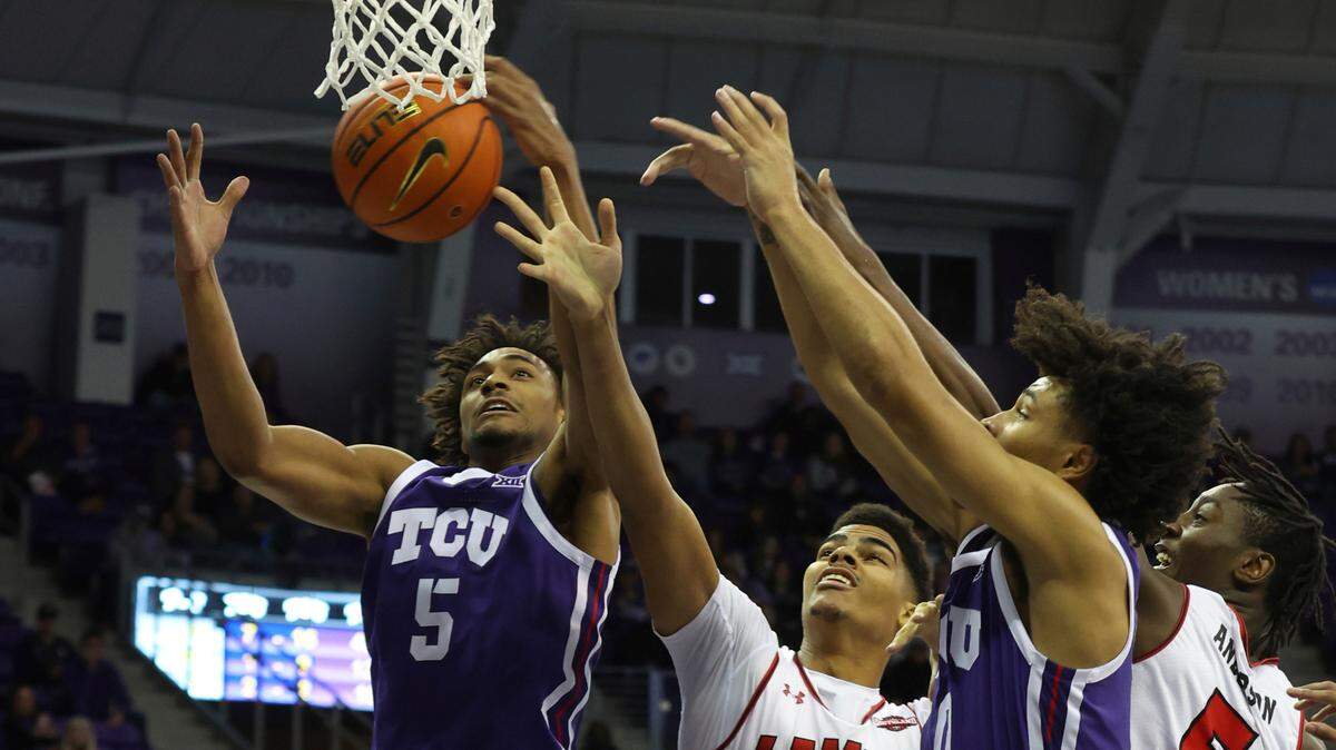 TCU forward Chuck O’Bannon Jr. (5) grabs a rebound against Lamar center Adam Hamilton (20) and forward Terry Anderson (5) in the first half during an NCAA college basketball game Friday, Nov. 11, 2022, in Fort Worth, Texas. (AP Photo/Richard W. Rodriguez)