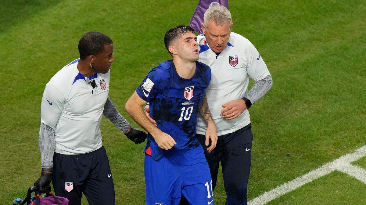 Christian Pulisic of the United States is helped by team doctors after he scoring his side’s opening goal during the World Cup group B soccer match between Iran and the United States at the Al Thumama Stadium in Doha, Qatar, on Tuesday.