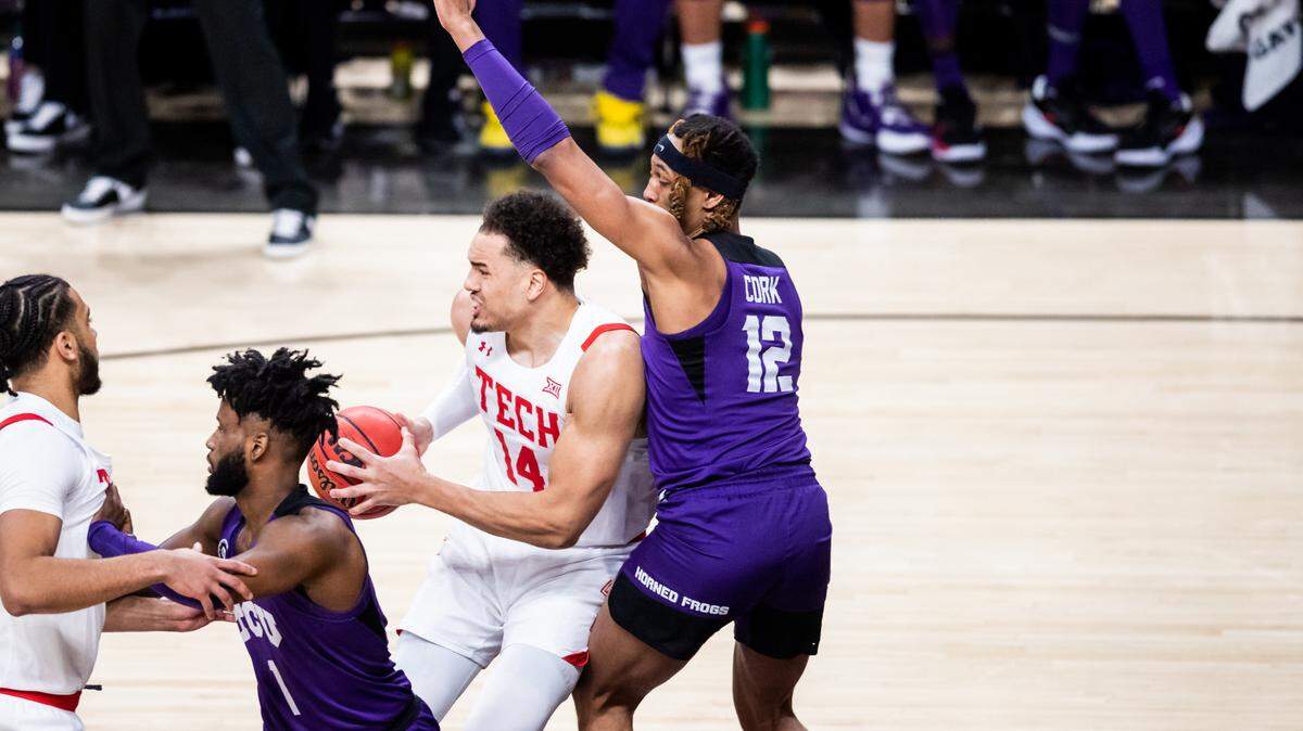 Texas Tech’s Marcos Santos-Silva works against TCU’s Xavier Cork during Saturday’s game at the United Supermarkets Arena in Lubbock.