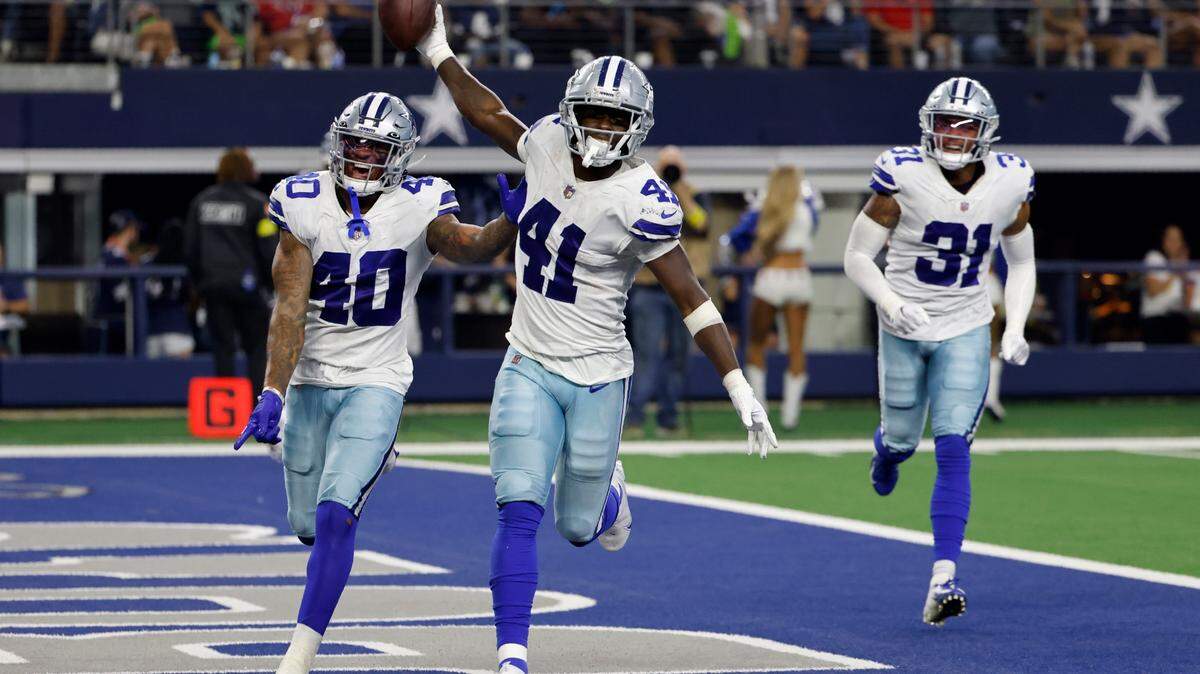 Dallas Cowboys’ Juanyeh Thomas (40) Markquese Bell (41) and Tyler Coyle (31) celebrate after Bell intercepted a pass against Seattle on Friday at AT&T Stadium.