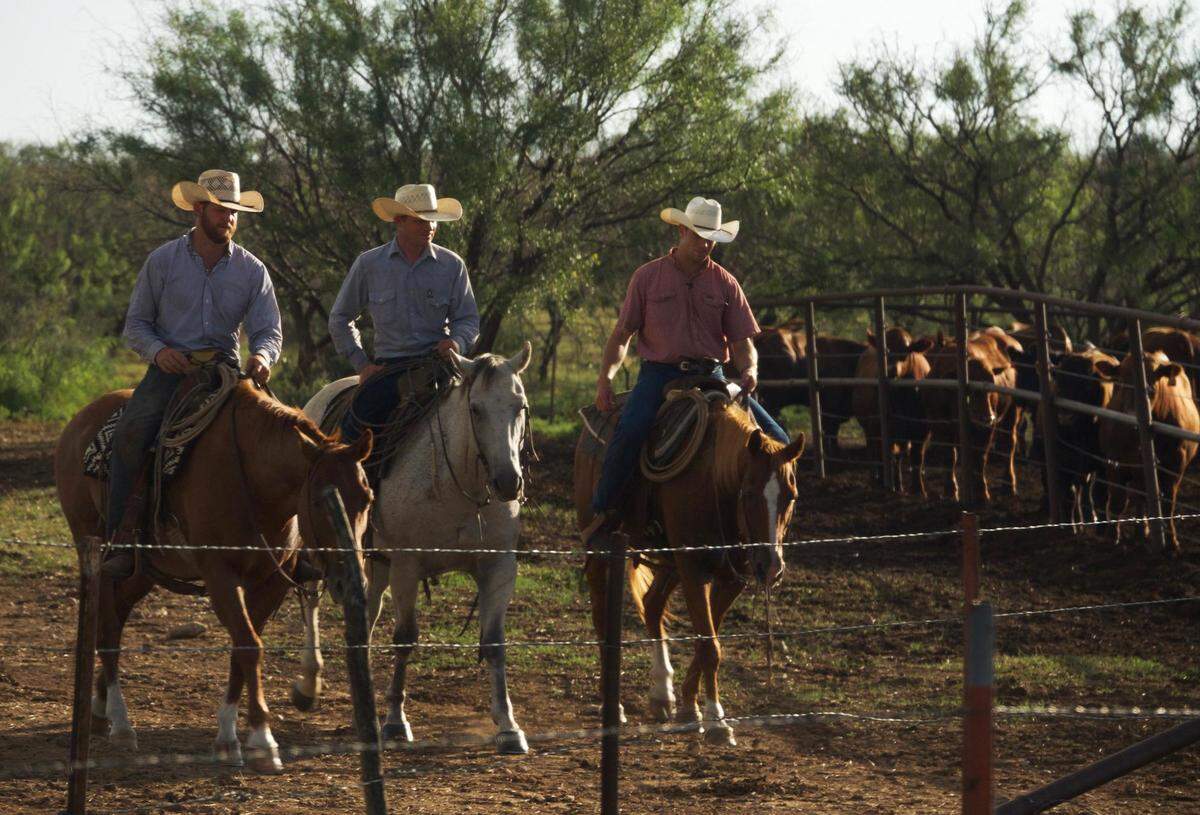 Tucker Brown (far left), RA Brown ranch foreman (middle) and director Gastón Davis at the RA Brown Ranch in Throckmorton, Texas, in the film ‘Cowboys Without Borders.’