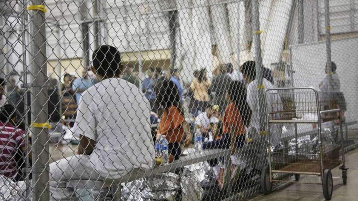 In this photo provided by U.S. Customs and Border Protection, people who've been taken into custody related to cases of illegal entry into the United States sit in one of the cages at a facility in McAllen.
