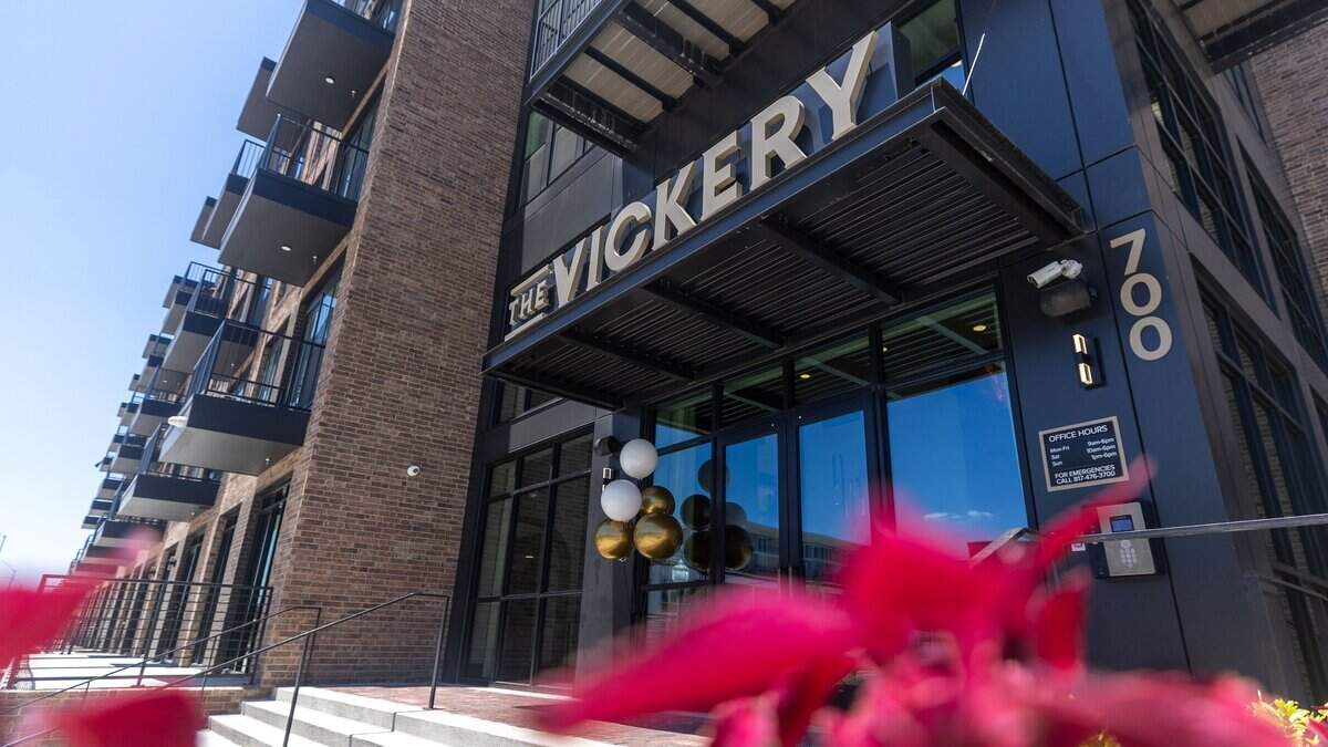 The entrance to The Vickery apartments stands behind a bed of flowers on Vickery Boulevard in Fort Worth on July 10, 2026.