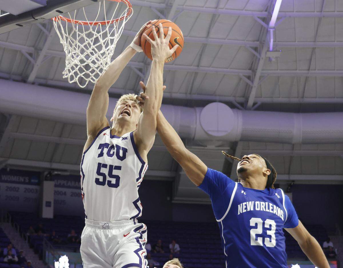 TCU guard Tanner Toolson (55) is fouled by New Orleans forward MJ Thomas (23) during the second half of a NCAA basketball game between New Orleans University and TCU at Schollmaier Arena in Fort Worth, Texas, Monday Nov. 03, 2025. The Horned Frogs dropped their home opener 78-74 to the Privateers.