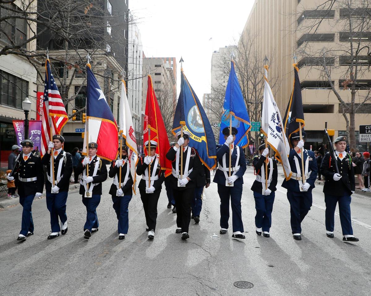 The Fort Worth ISD Jr. ROTC color guard step off the 2023 Martin Luther King Jr. Day parade in downtown Fort Worth.