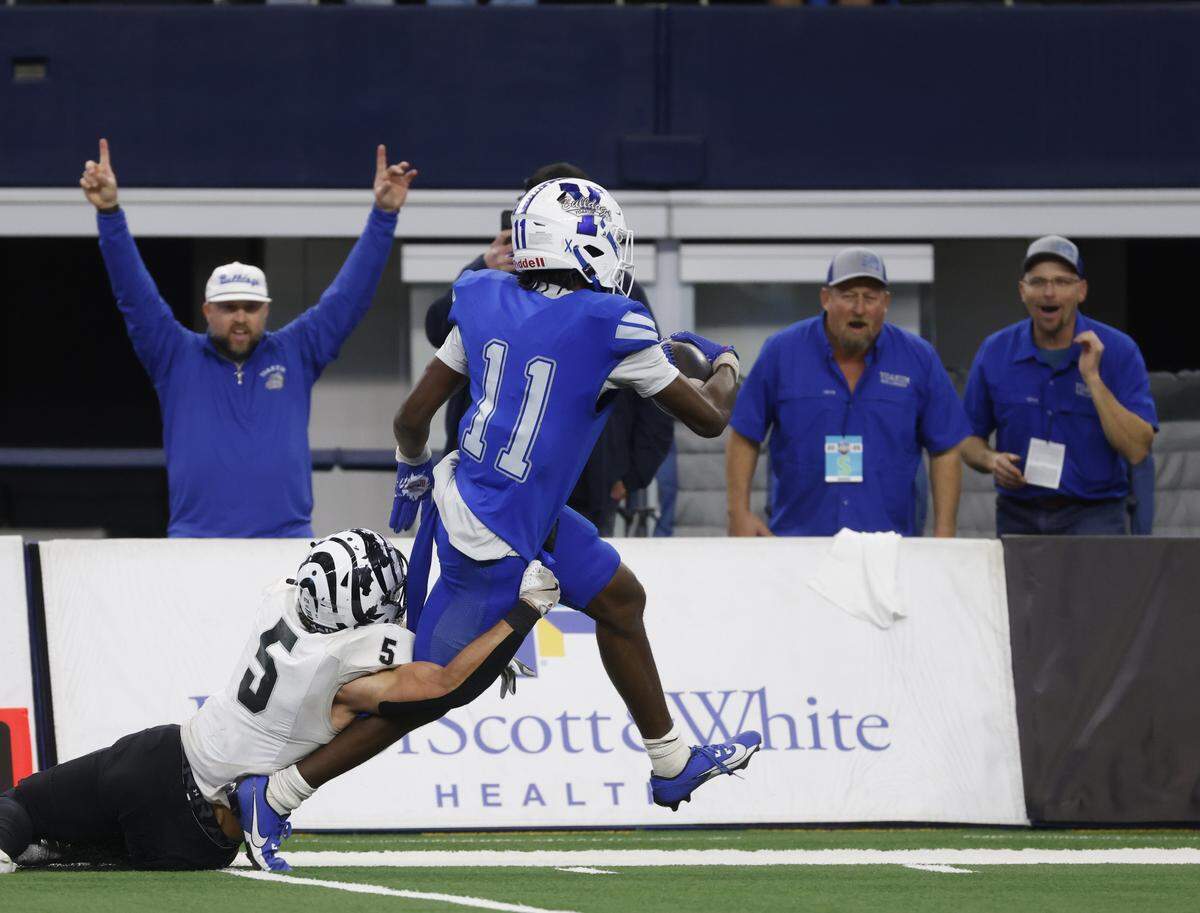 Grandview middle linebacker Bleu Hubbard (5) hands on as Yoakum wide receiver X'Zavier Barnett (11) scores during the first half of a UIL Class 3A Division I championship game on Thursday Dec. 18, 2025 at AT&T Stadium in Arlington, Texas.