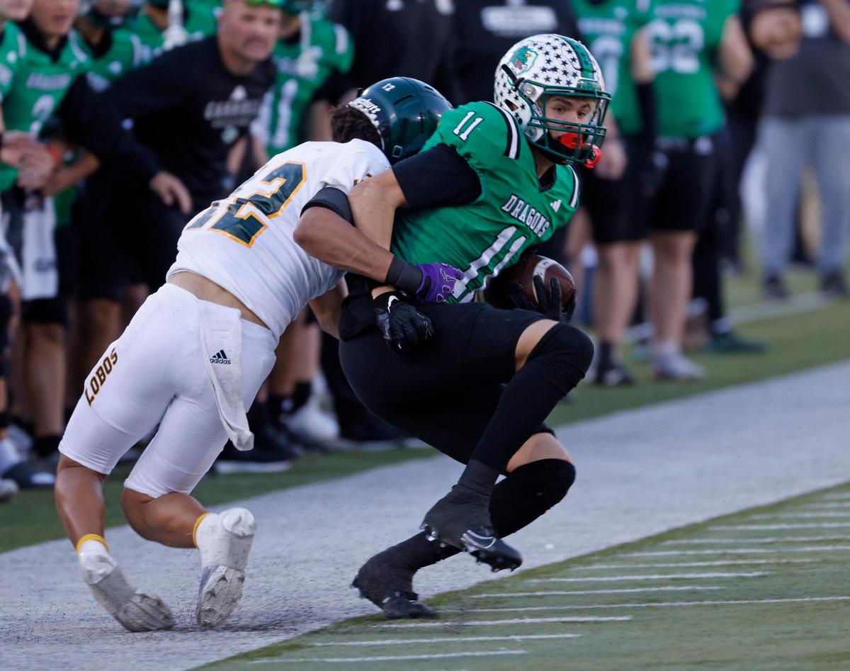 Longview defensive back Bryan Peoples (12) takes Southlake Carroll wide receiver Brock Boyd (11) out of bounds after the catch during the UIL 6A D2 Semifinals football game at Gerald J. Ford Stadium in University Park, Texas, Saturday, Dec. 14, 2024.