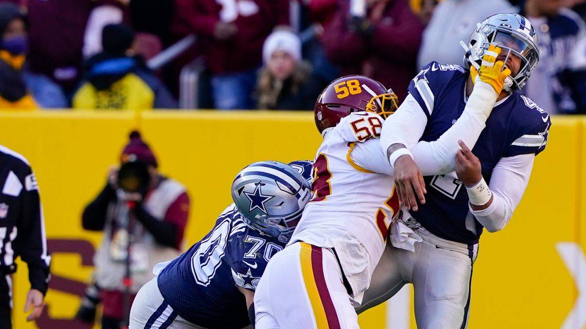 Dallas Cowboys quarterback Dak Prescott is pressured to throw the ball early by Washington Football Team defensive end Shaka Toney during the first half Sunday. In the fourth quarter, Cowboys teammates came to Prescott’s defense after a hard shove out of bounds by defensive end James Smith-Williams.