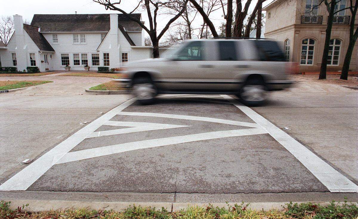 An SUV goes over a speed hump on Crestline Road on Fort Worth's westside on March 1, 2001.