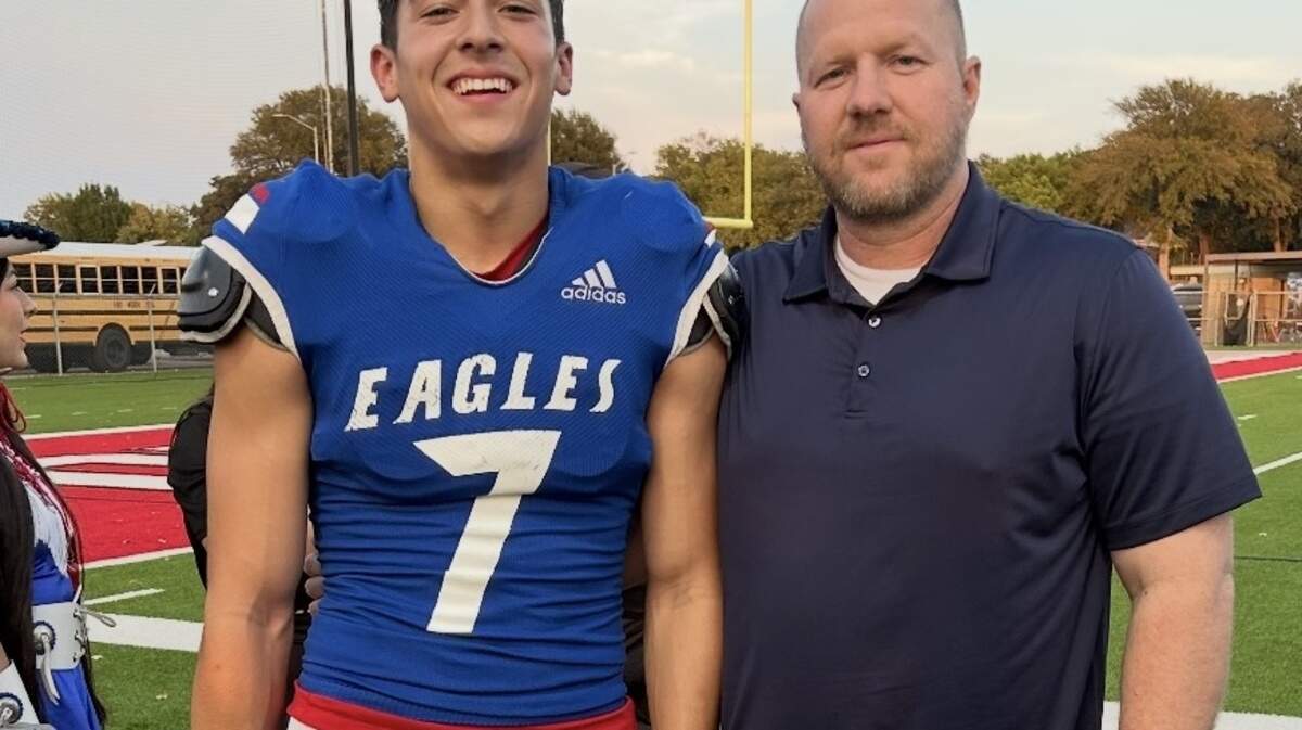Ryan Walters (left) and Michael Walters pose for a picture after a football game. Both made rare playoff appearances for Fort Worth Carter-Riverside.