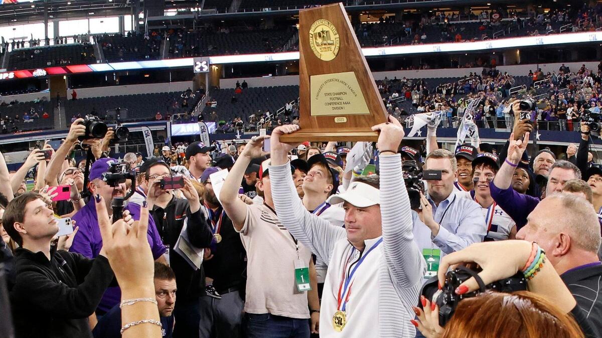Anna head coach Seth Parr displays the championship plaque after the UIL Conference 4A Division 1 state championship football game at AT&T Stadium in Arlington, Texas, Thursday, Dec. 14, 2023.
