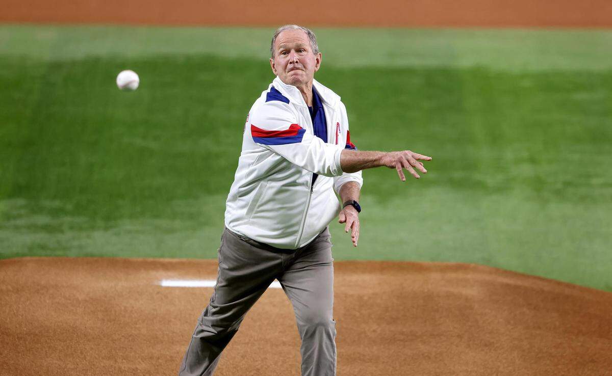 former United States President George W. Bush throws the first pitch of Game 1 of the World Series between the Texas Rangers and the Arizona Diamondbacks on Friday, October 27, 2023, at Globe Life Field in Arlington.